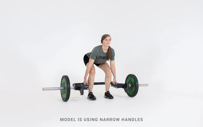 Lifter set up for a deadlift using the open trap bar with narrow handles.